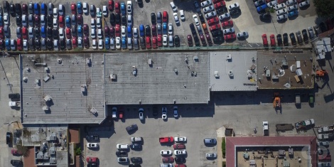 Before image of the roofing system at a strip center in San Antonio, TX, showing existing conditions prior to installation